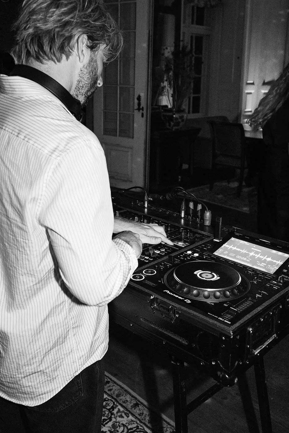 DJ Vejlgaard at the decks at a company celebration