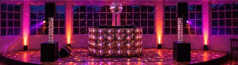 DJ booth with disco ball at night